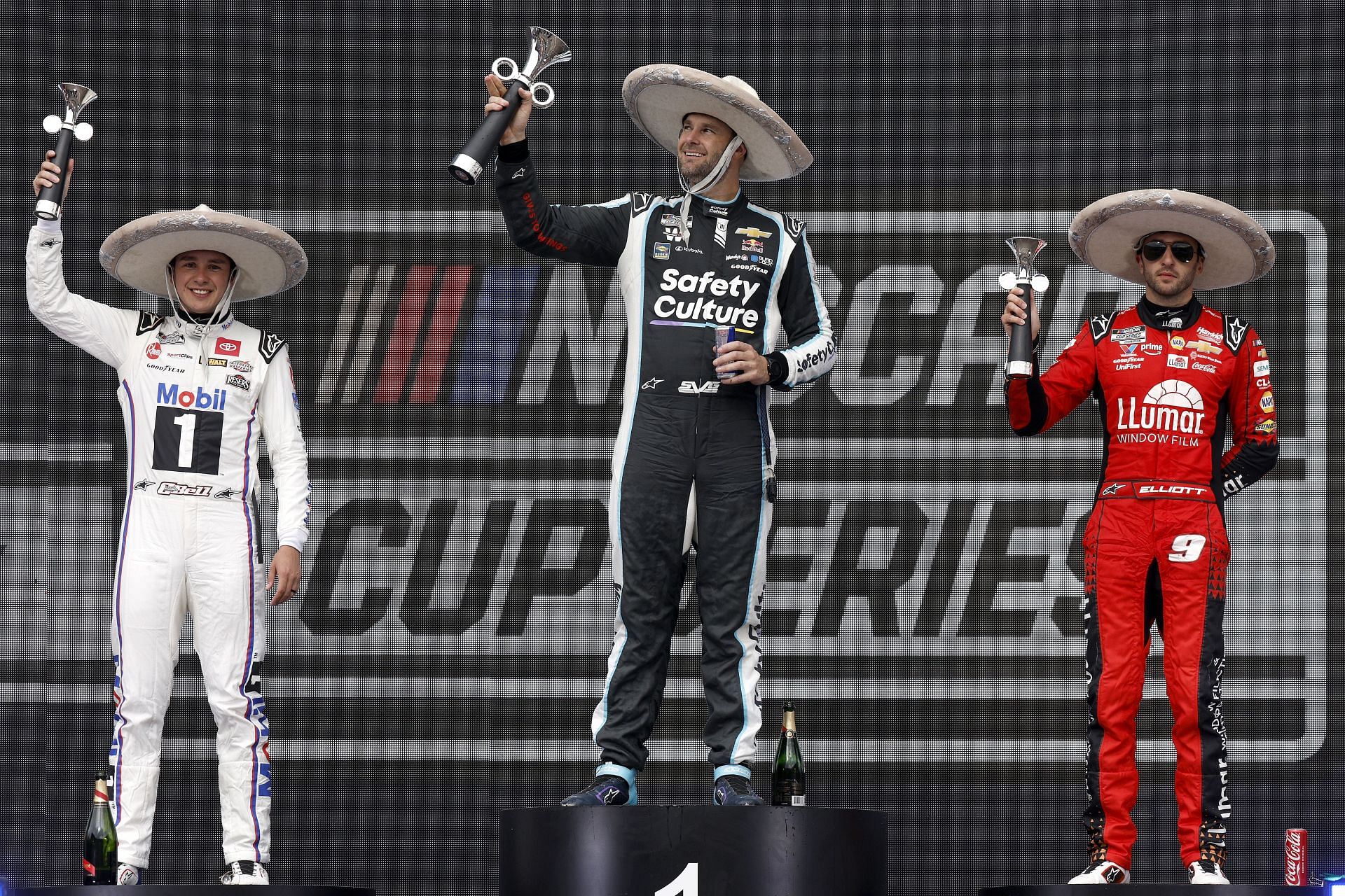 Shane Van Gisbergen, (winner) Christopher Bell, (second place) and Chase Elliott (third place) celebrate in victory lane at the Cup Series race the Viva Mexico 250 at Autodromo Hermanos Rodriguez, in Mexico - Source: Getty